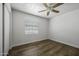 Bright bedroom features wood-look floors, a ceiling fan, and a window at 2929 E Broadway Rd # 44, Mesa, AZ 85204