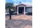 Charming home featuring a welcoming front entrance with a decorative palm tree and well-maintained landscaping at 2929 E Broadway Rd # 44, Mesa, AZ 85204