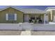 Charming single-story home with a white brick fence and front porch seating under an Arizona blue sky at 2929 E Broadway Rd # 44, Mesa, AZ 85204