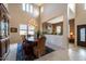 Formal dining room features soaring ceilings, a chandelier, and views into the living room and entry at 3126 E San Angelo Ave, Gilbert, AZ 85234