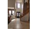 An entryway foyer featuring high ceilings, decorative front door and tile flooring leading to a staircase at 3126 E San Angelo Ave, Gilbert, AZ 85234