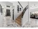 Bright foyer featuring hardwood stairs, marble floors, and views of the fireplace and dining room at 36039 N 58Th St, Cave Creek, AZ 85331