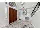 Grand foyer boasts marble floors, high ceilings, and a striking modern light fixture at 36039 N 58Th St, Cave Creek, AZ 85331