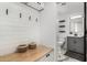 Hallway with a bench, hooks, leading to a bathroom with marble floors at 36039 N 58Th St, Cave Creek, AZ 85331