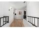 Upstairs hallway with hardwood floors, black railing, and lots of natural light at 36039 N 58Th St, Cave Creek, AZ 85331