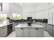 Bright kitchen features an island with gray countertops, custom cabinets, and modern stainless appliances at 36039 N 58Th St, Cave Creek, AZ 85331
