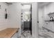 Modern laundry room with white cabinets, black appliances, and marble-look flooring at 36039 N 58Th St, Cave Creek, AZ 85331