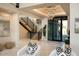 Elegant entryway with a floating staircase and modern chandelier at 36420 N 105Th Pl, Scottsdale, AZ 85262