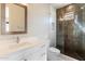 Modern bathroom with a walk-in shower, white vanity, and mosaic mirror at 4401 E Sunset Dr, Phoenix, AZ 85028