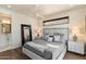 Bright bedroom with a comfortable bed, large mirror, and ensuite bathroom access at 4401 E Sunset Dr, Phoenix, AZ 85028
