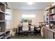 Home office with built-in shelving, dual monitors, and ample workspace at 4401 E Sunset Dr, Phoenix, AZ 85028