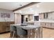 Gourmet kitchen with expansive island, granite countertops, and modern cabinetry at 4401 E Sunset Dr, Phoenix, AZ 85028