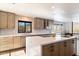 Modern kitchen with large island, stainless steel appliances, and wood cabinets at 4401 E Sunset Dr, Phoenix, AZ 85028