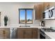 Modern kitchen with stainless steel appliances and wood cabinets at 4401 E Sunset Dr, Phoenix, AZ 85028