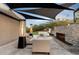 Relaxing patio featuring fireplace, seating, and shade sails at 4401 E Sunset Dr, Phoenix, AZ 85028