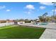 Backyard oasis with a large pool, grassy area, and patio seating at 4401 E Sunset Dr, Phoenix, AZ 85028