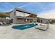 Luxury backyard oasis with a glistening pool, fire pit, and comfortable seating at 4401 E Sunset Dr, Phoenix, AZ 85028