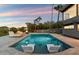 Relaxing pool area with floating loungers and fire feature at 4401 E Sunset Dr, Phoenix, AZ 85028