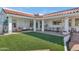 Backyard oasis with a grassy lawn, dining area, and hanging swing at 4601 E Solano Dr, Phoenix, AZ 85018