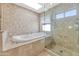 Spa-like bathroom with soaking tub and walk-in shower at 4601 E Solano Dr, Phoenix, AZ 85018