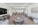 Open and airy living room with neutral decor and large TV at 4601 E Solano Dr, Phoenix, AZ 85018