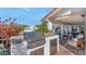 Outdoor kitchen with stainless steel grill and seating area at 4601 E Solano Dr, Phoenix, AZ 85018