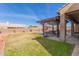 Spacious backyard with covered patio, built-in grill, and grassy area at 4966 E Juana Ct, Cave Creek, AZ 85331