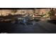 Expansive backyard with a pond and lush landscaping at night at 4966 E Juana Ct, Cave Creek, AZ 85331