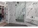Modern bathroom with walk-in shower and marble tile at 4966 E Juana Ct, Cave Creek, AZ 85331