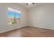 Bright bedroom featuring wood-look floors and a large window at 4966 E Juana Ct, Cave Creek, AZ 85331
