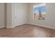 Bedroom with wood-look floors, window, and large closet at 4966 E Juana Ct, Cave Creek, AZ 85331