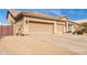 Three-car garage with desert landscaping and a wooden fence at 4966 E Juana Ct, Cave Creek, AZ 85331