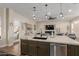 Open kitchen with island seating and a view into the living room at 4966 E Juana Ct, Cave Creek, AZ 85331
