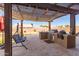 Outdoor kitchen with built-in grill, pergola, and seating area at 4966 E Juana Ct, Cave Creek, AZ 85331