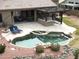 Relaxing pool area with pergola, outdoor kitchen, and lounge chairs at 4966 E Juana Ct, Cave Creek, AZ 85331