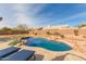 Inviting kidney-shaped pool with surrounding patio at 4966 E Juana Ct, Cave Creek, AZ 85331