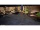 Night view of a backyard pool and patio with lounge chairs at 4966 E Juana Ct, Cave Creek, AZ 85331