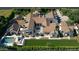 Aerial view of a sprawling estate featuring a pool, lush lawns, and meticulously designed gardens at 6235 E Montecito Ave, Scottsdale, AZ 85251