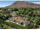 Stunning aerial view of a luxury estate with a pool, manicured lawns, and majestic mountain views at 6235 E Montecito Ave, Scottsdale, AZ 85251