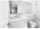Bright bathroom features white cabinets, rectangular mirror, and a shower over a soaking tub at 6235 E Montecito Ave, Scottsdale, AZ 85251