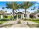 Beautiful home with meticulously maintained landscaping, a striking front entrance and a stone walkway at 6235 E Montecito Ave, Scottsdale, AZ 85251