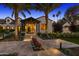 Stunning home exterior featuring a walkway flanked by palm trees, flowers, and a covered entry at 6235 E Montecito Ave, Scottsdale, AZ 85251