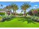 Gorgeous front yard with lush green lawn, mature palm trees, and manicured landscaping at 6235 E Montecito Ave, Scottsdale, AZ 85251