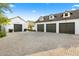 Spacious three-car garage and a matching one-car garage with charming dormer windows and a paved driveway at 6235 E Montecito Ave, Scottsdale, AZ 85251