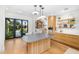 Bright kitchen boasts wood cabinets, a gray countertop, and an exterior view to the backyard at 6235 E Montecito Ave, Scottsdale, AZ 85251