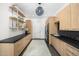 Well-organized laundry room with modern cabinets, open shelves, and sleek appliances at 6235 E Montecito Ave, Scottsdale, AZ 85251