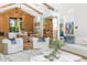 Open concept living room with hardwood floors, high ceilings, bar and a wine cellar at 6235 E Montecito Ave, Scottsdale, AZ 85251