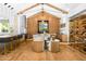 Open floor plan featuring kitchen, living room with chairs, wood floors and a wine cellar at 6235 E Montecito Ave, Scottsdale, AZ 85251
