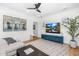 Relaxing living room with comfortable seating, a large TV, and ample natural light from surrounding windows at 6235 E Montecito Ave, Scottsdale, AZ 85251