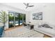 Cozy living room with comfortable white sectional sofa, ceiling fan, and views of the private pool area at 6235 E Montecito Ave, Scottsdale, AZ 85251